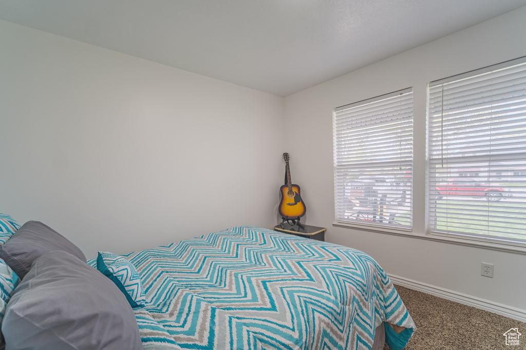 Carpeted bedroom with baseboards