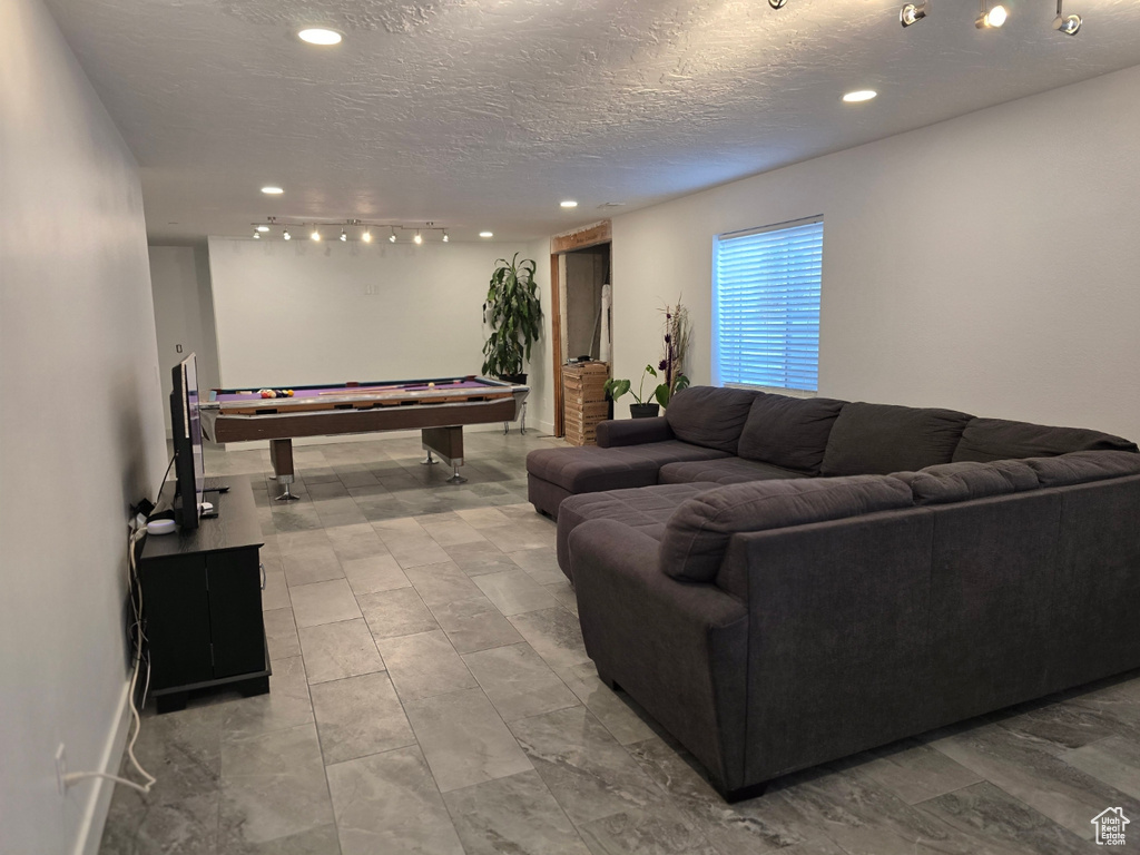 Living room with billiards table, recessed lighting, and a textured ceiling