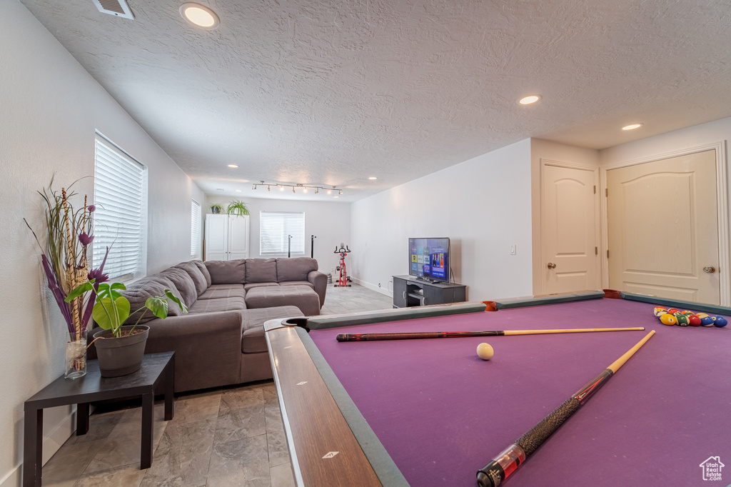 Recreation room with a textured ceiling, billiards, recessed lighting, and baseboards