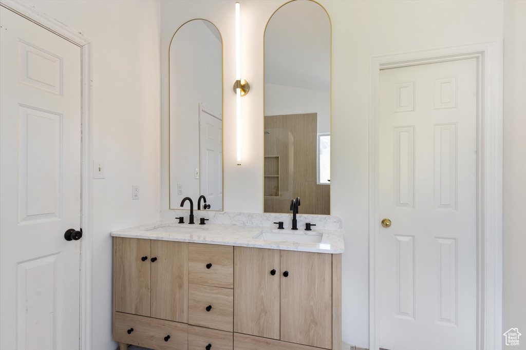 Bathroom with double vanity and vaulted ceiling