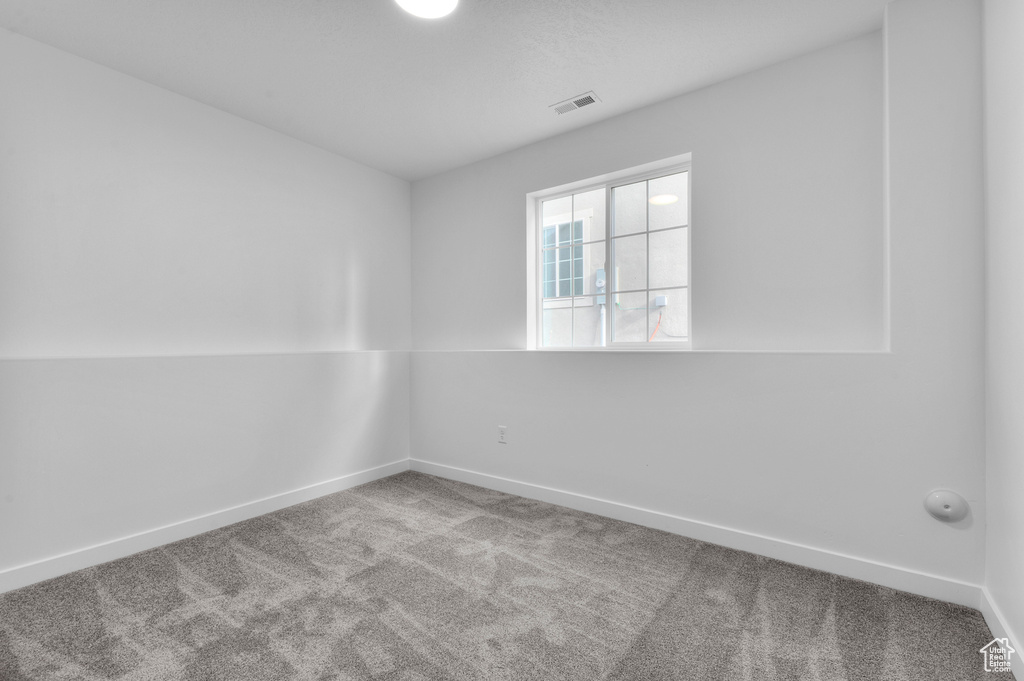 Unfurnished room with carpet flooring and baseboards