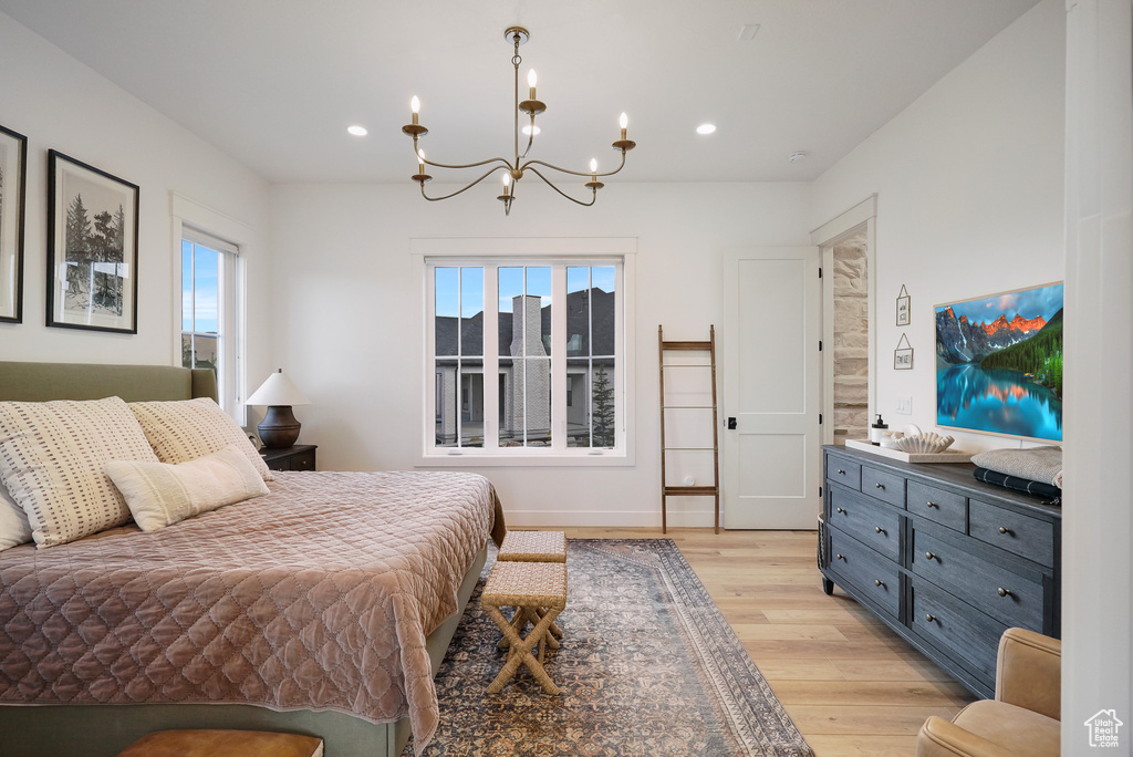 Bedroom with light wood-style floors, a chandelier, multiple windows, recessed lighting, and baseboards