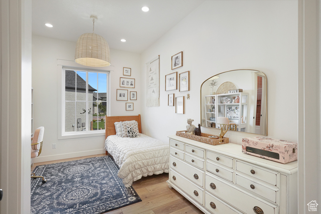 Bedroom featuring light wood finished floors, recessed lighting, and baseboards