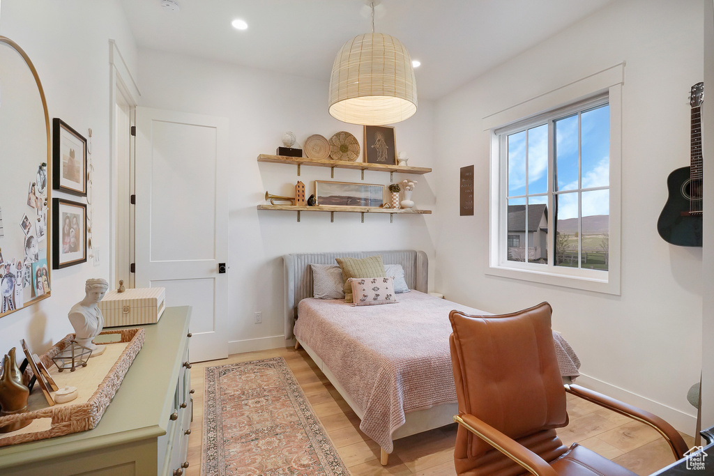Bedroom featuring light wood-style floors, recessed lighting, and baseboards