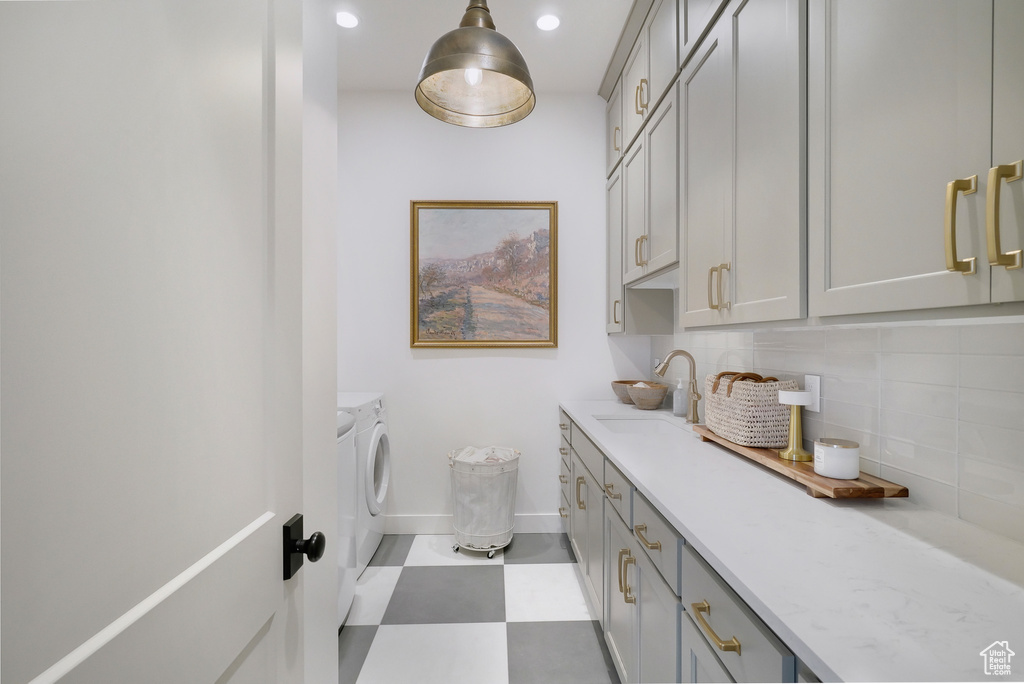 Laundry area with independent washer and dryer, baseboards, cabinet space, tile patterned floors, and recessed lighting