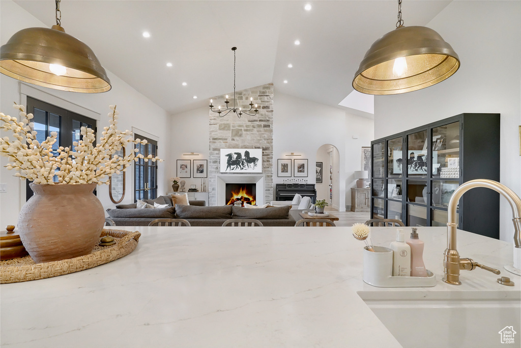 Building lobby with high vaulted ceiling, a sink, and recessed lighting