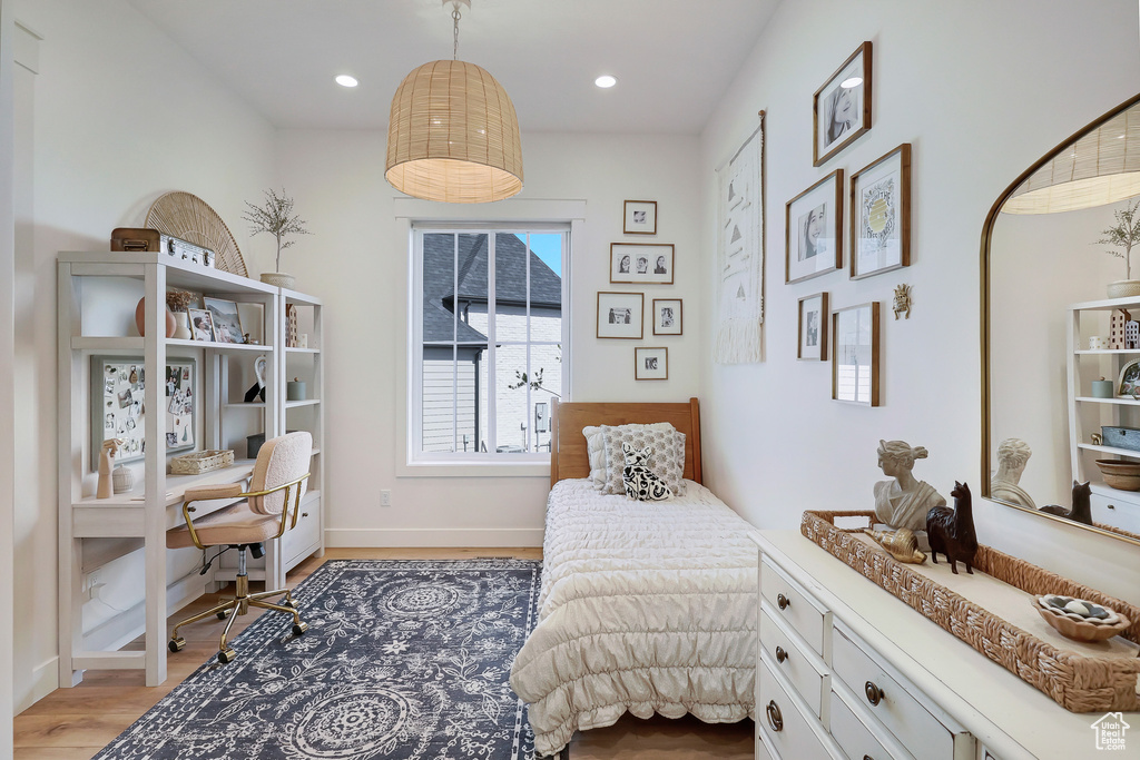 Bedroom featuring an office area, light wood finished floors, recessed lighting, and baseboards