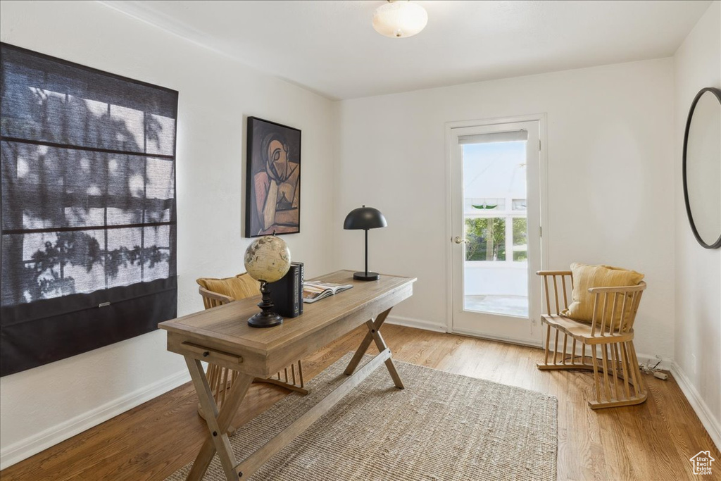 Office space with light wood finished floors and baseboards
