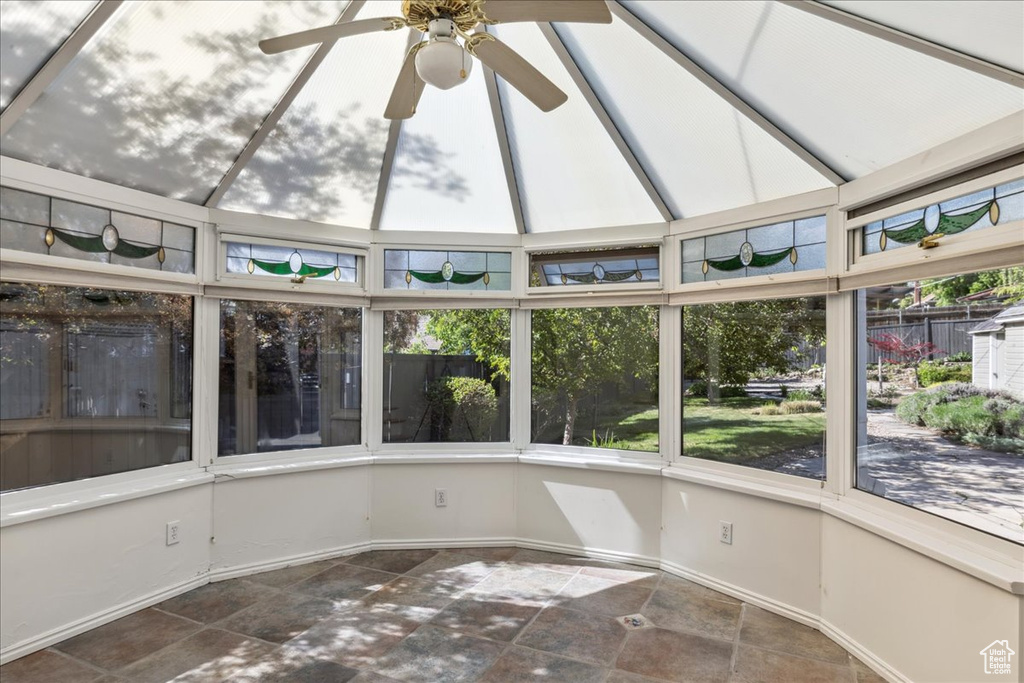 Unfurnished sunroom featuring healthy amount of natural light and baseboards