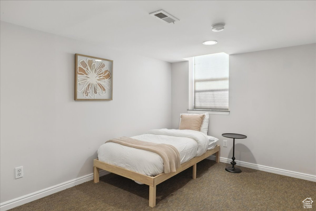 Carpeted bedroom with baseboards