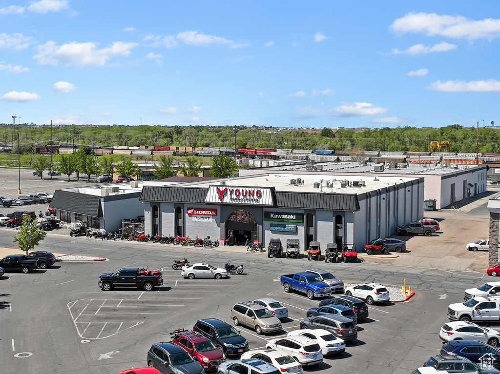 Drone / aerial view of a commercial area and a tree filled landscape