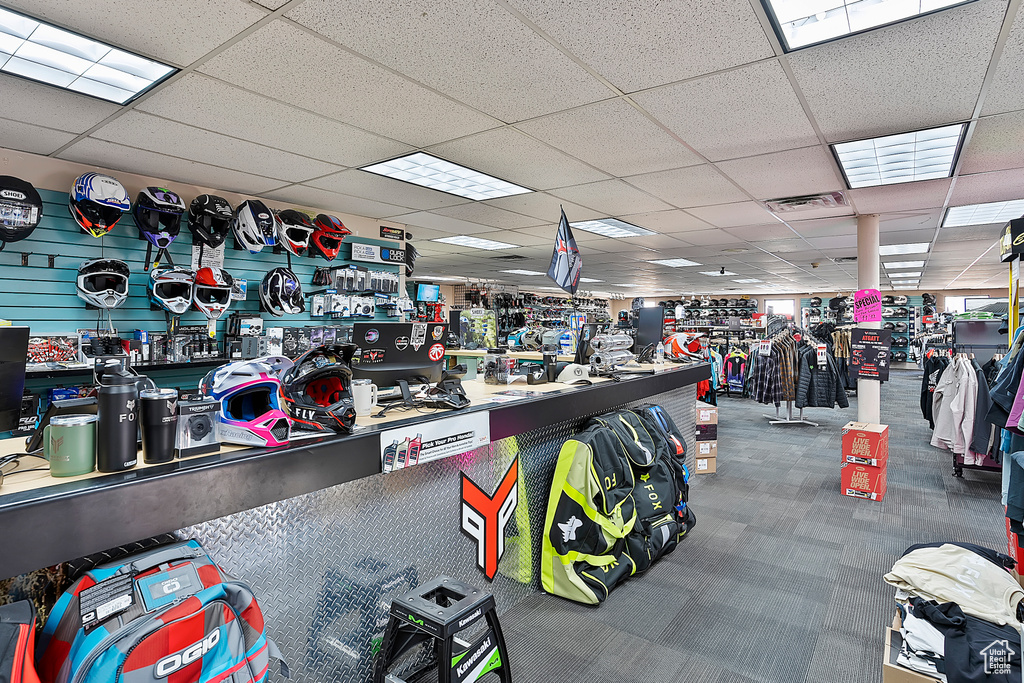 Miscellaneous room featuring a drop ceiling and carpet floors