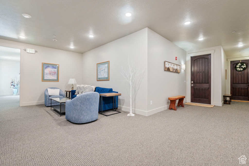 Sitting room featuring carpet flooring, baseboards, and recessed lighting
