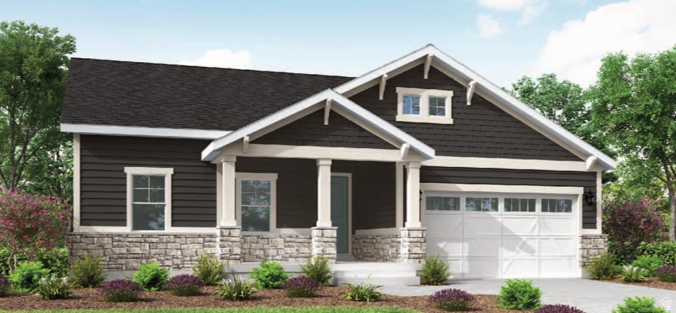 View of front of home with stone siding, a porch, driveway, and an attached garage