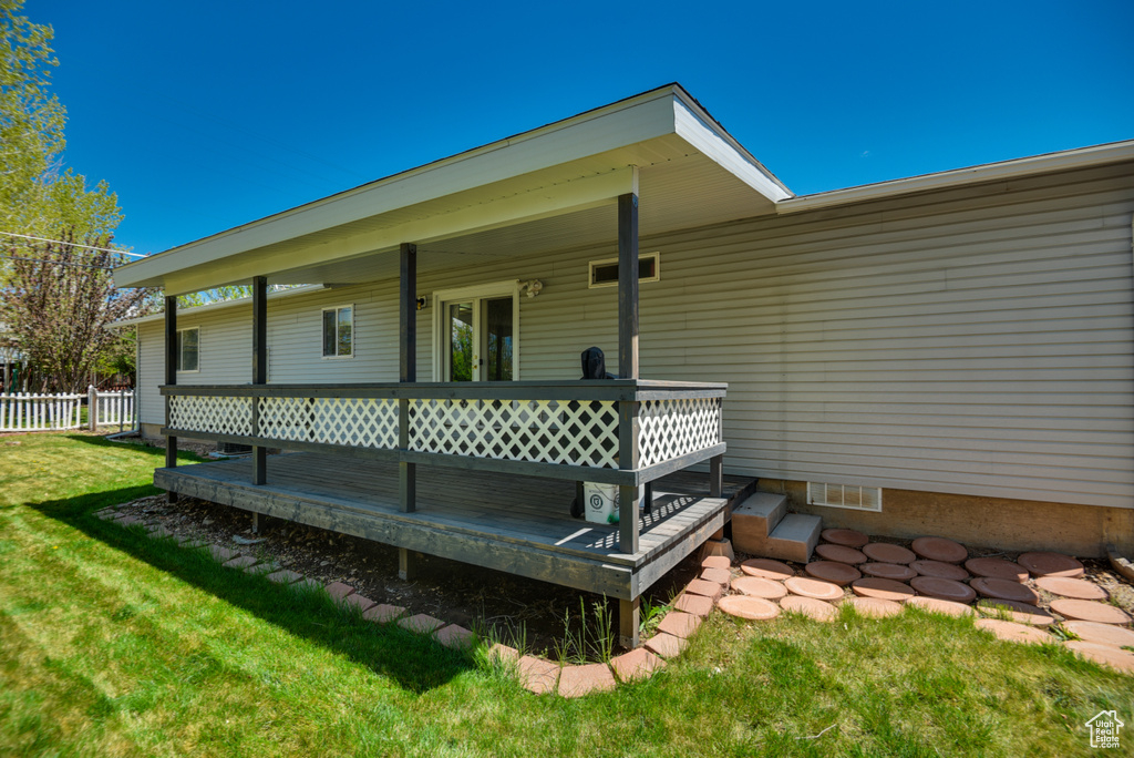 Doorway to property with a wooden deck and crawl space