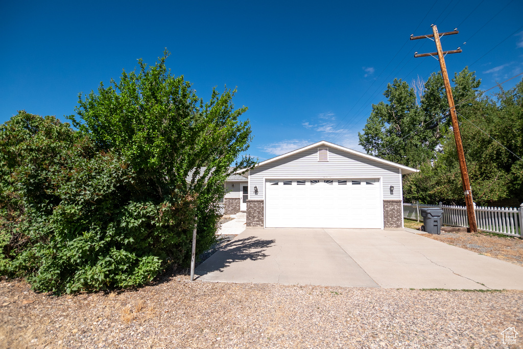View of front of property with brick siding and a garage