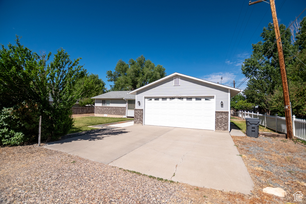 Ranch-style home featuring brick siding and driveway