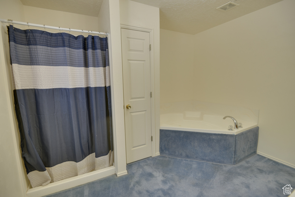 Full bath featuring a bath, a shower with curtain, and baseboards