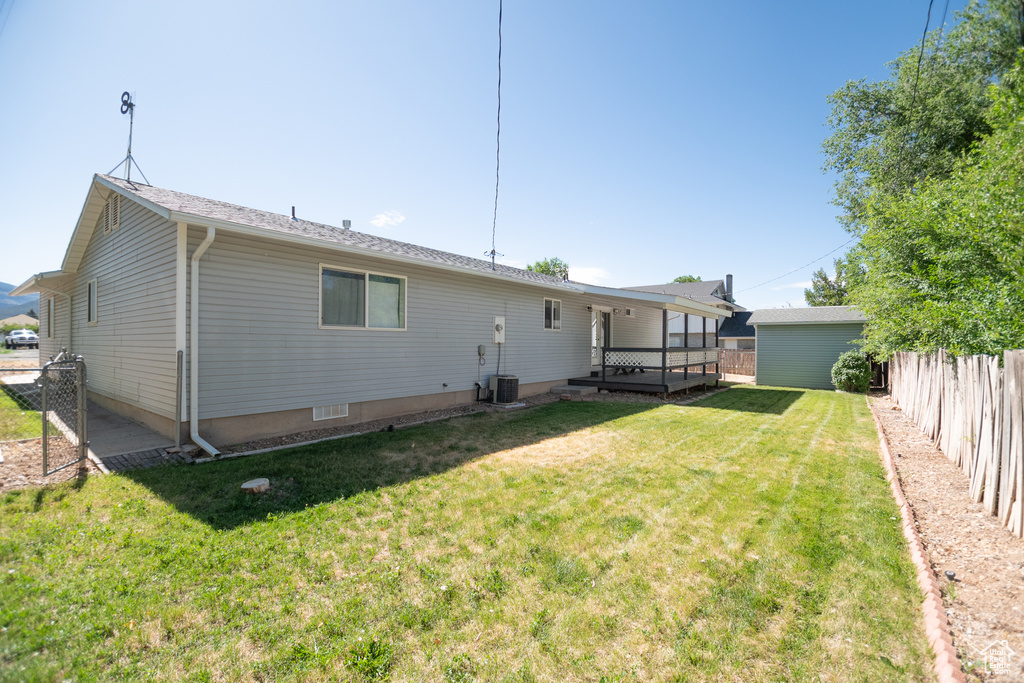 Back of property featuring a wooden deck