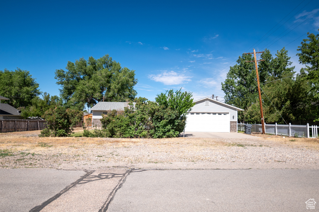 View of front of home featuring concrete driveway, brick siding, and an attached garage