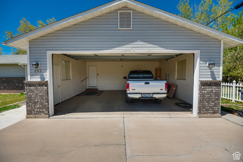 Garage with fence and concrete driveway