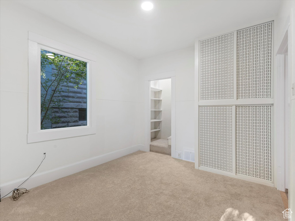 Unfurnished bedroom featuring carpet flooring and baseboards