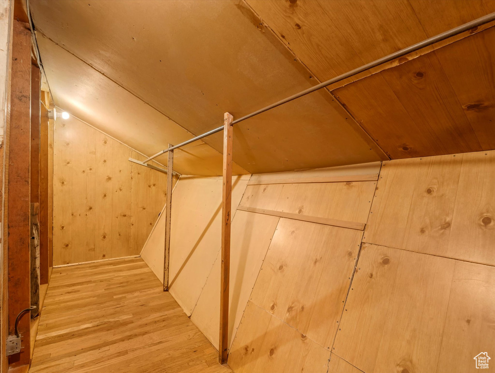 Spacious closet with wood finished floors and lofted ceiling
