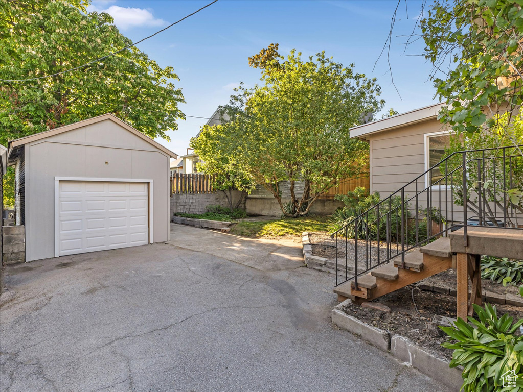 Detached garage with driveway and fence