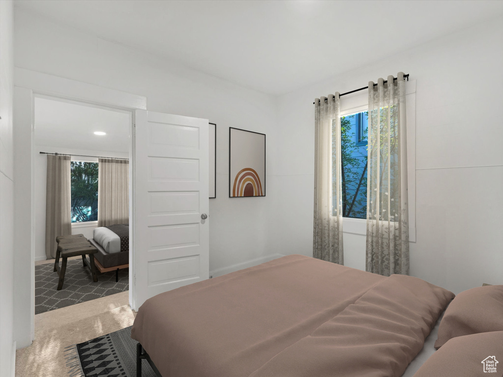 Carpeted bedroom with multiple windows