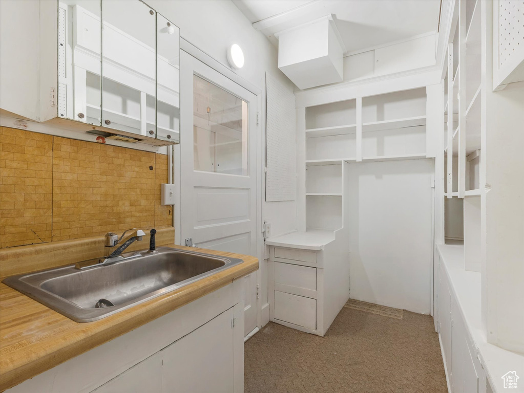 Bathroom with a sink and decorative backsplash