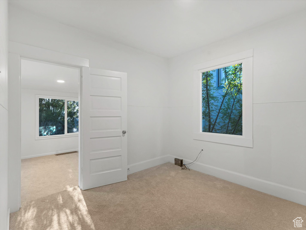 Carpeted empty room with baseboards