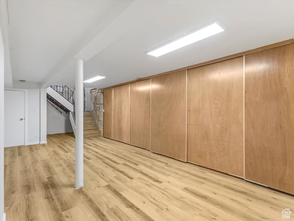 Bonus room with light wood finished floors and stairway