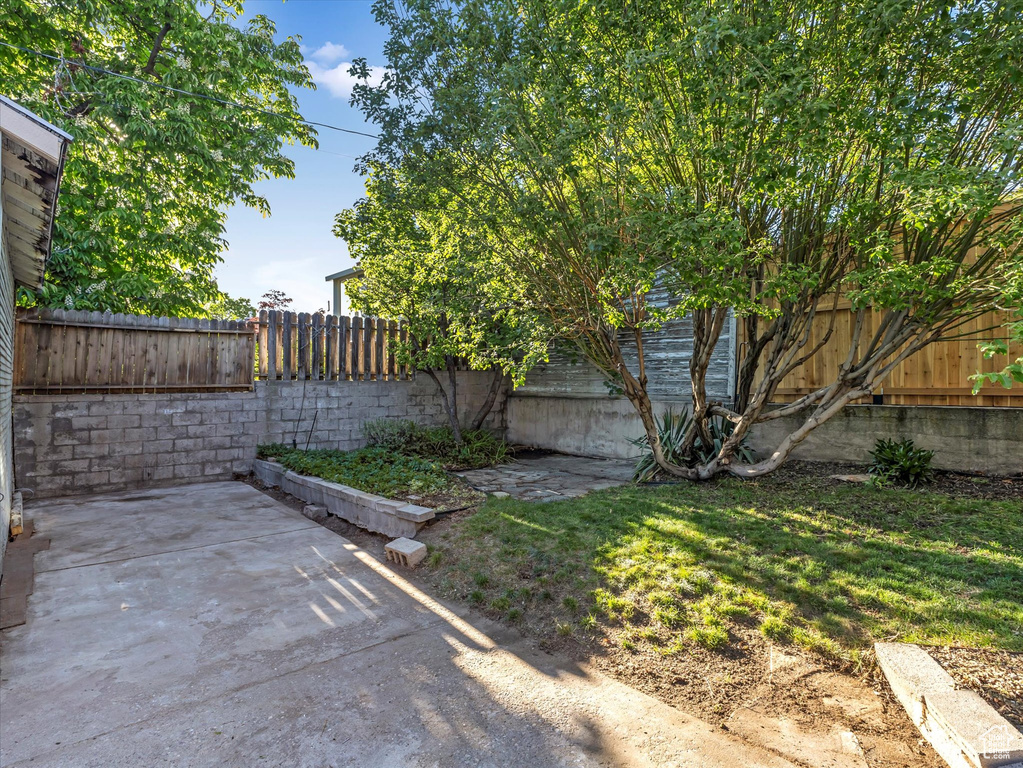 Fenced backyard with a patio
