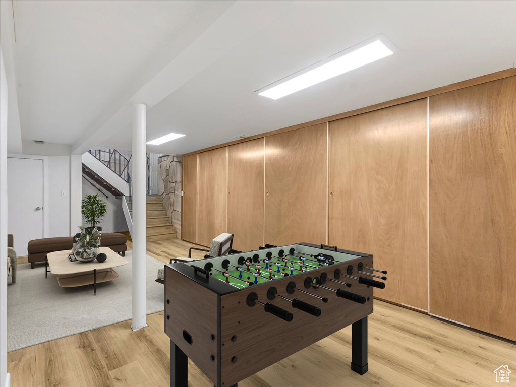 Game room with light wood-style flooring