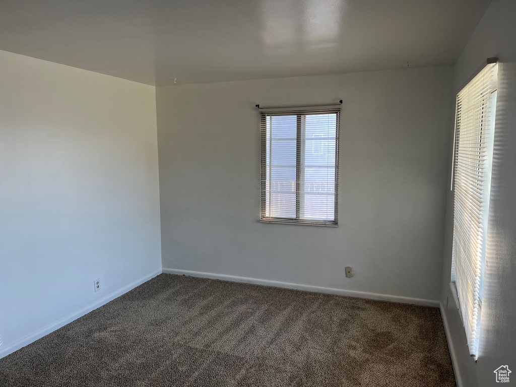 Carpeted spare room with baseboards