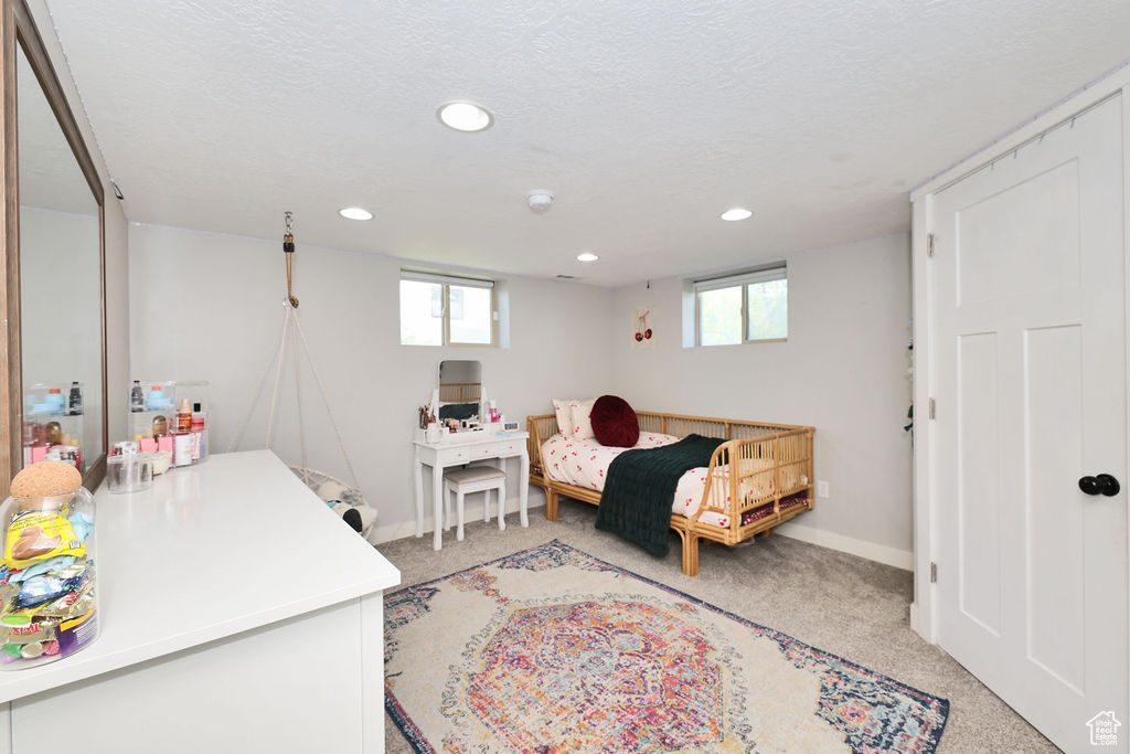 Bedroom with light carpet, recessed lighting, baseboards, and a textured ceiling