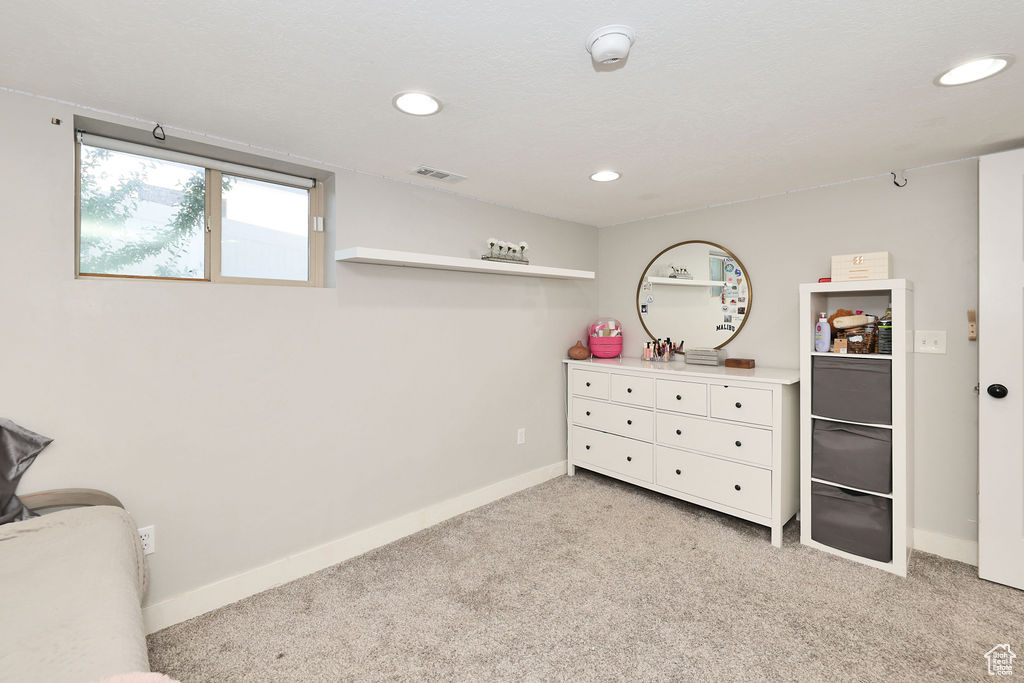 Bedroom with light carpet, recessed lighting, and baseboards