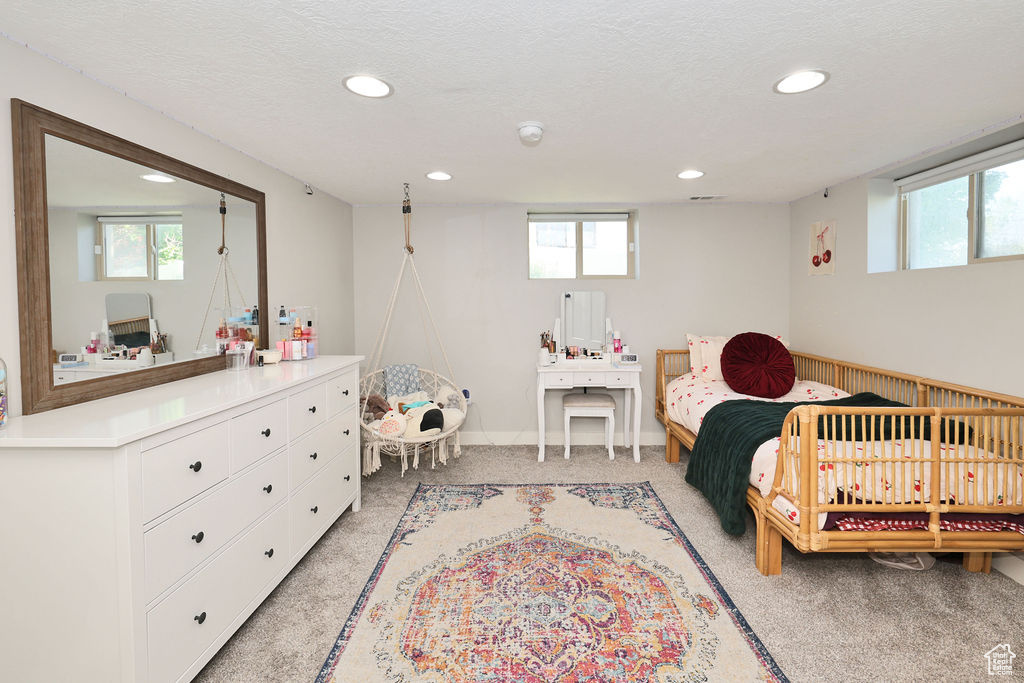 Bedroom with recessed lighting, multiple windows, light colored carpet, and baseboards
