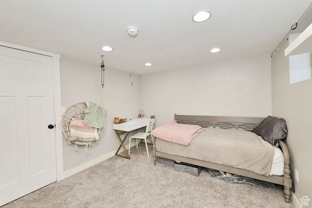 Carpeted bedroom featuring recessed lighting and baseboards