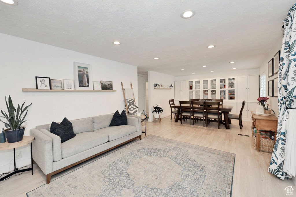 Living room with wood finished floors and recessed lighting