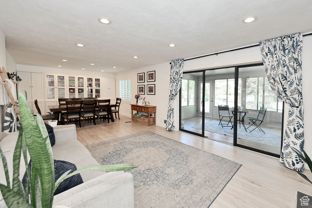 Living room with wood finished floors and recessed lighting
