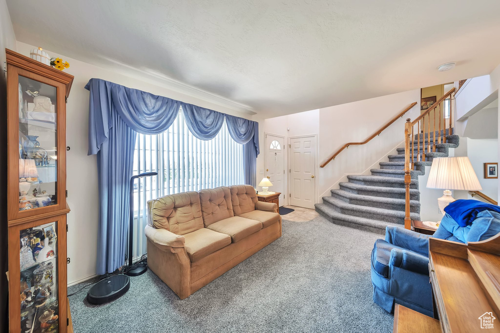 Living room with stairway and carpet