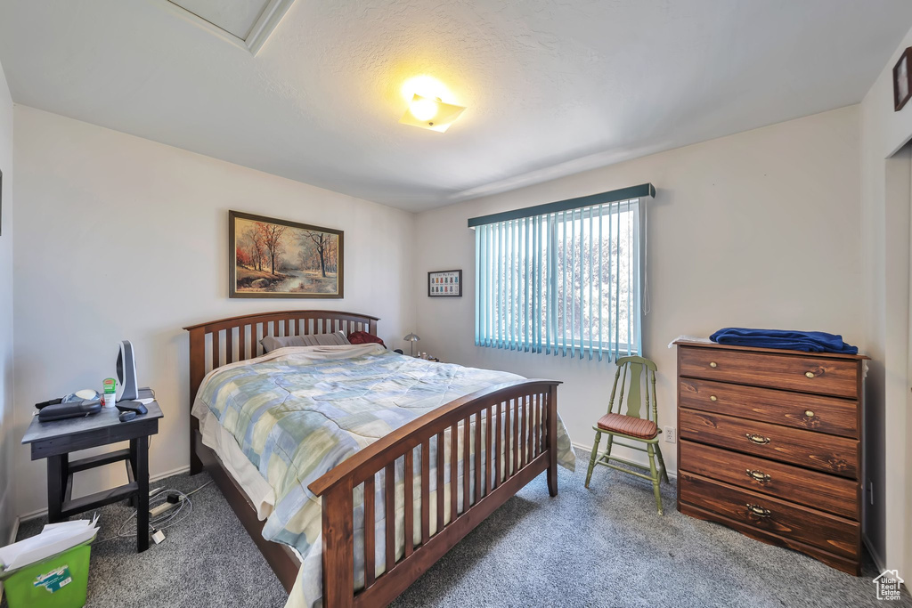Bedroom featuring carpet floors and baseboards