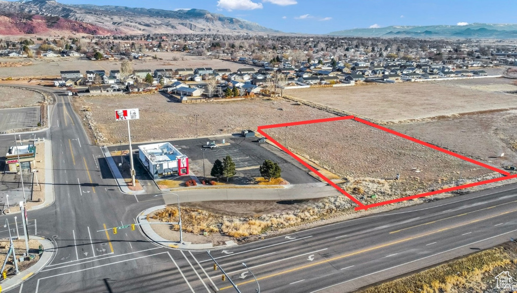 Aerial view of property\'s location with a mountain backdrop and property parcel outlined