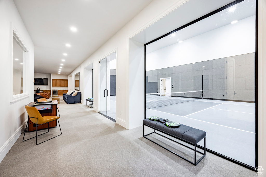 Corridor with baseboards, recessed lighting, and carpet