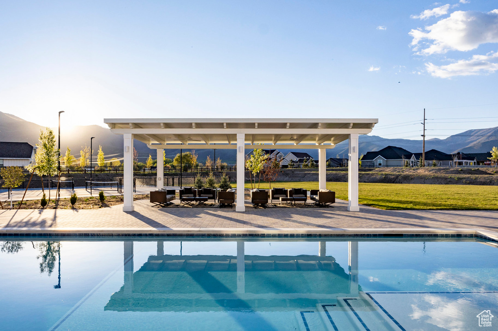 Swimming pool with a mountain view, outdoor lounge area, and a patio