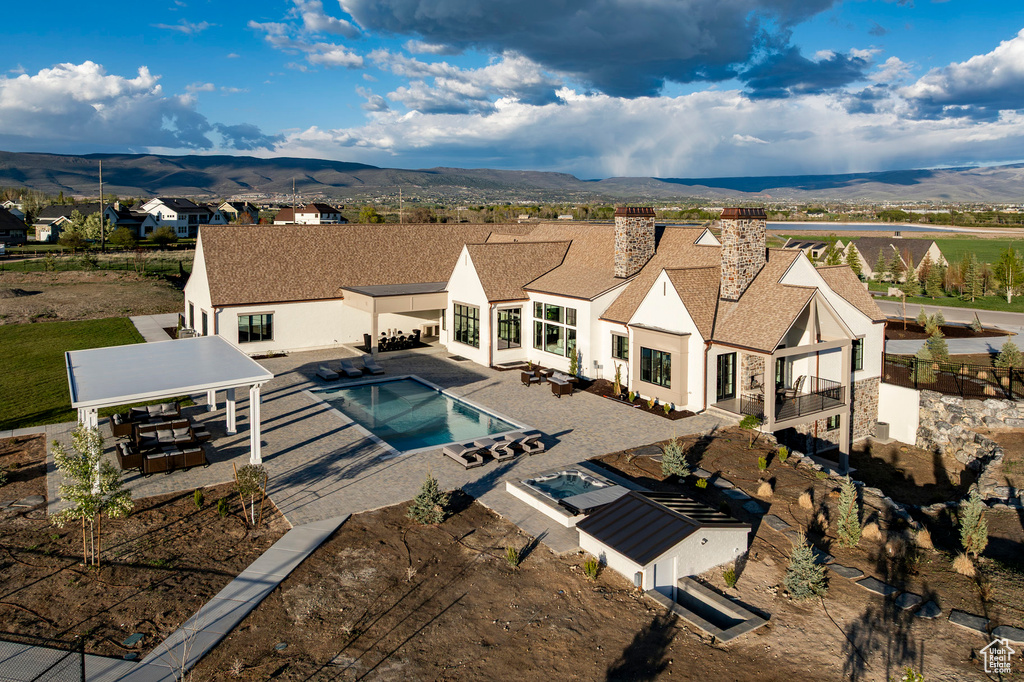 View of swimming pool with a gazebo, a mountain view, a patio area, and a fenced backyard