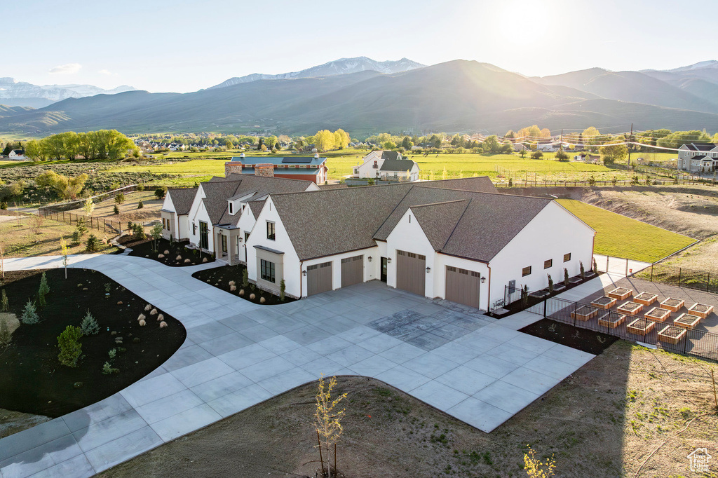 Aerial view of property and surrounding area with a mountainous background
