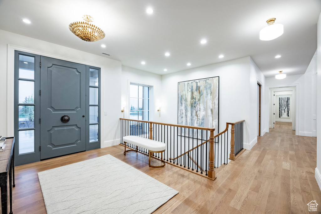 Foyer featuring light wood-type flooring, recessed lighting, and baseboards