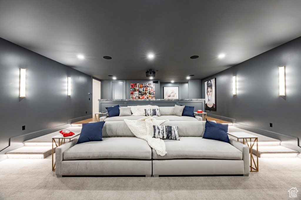 Carpeted home theater room with baseboards and recessed lighting